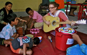 a Volunteer Playing Guitar For the Children